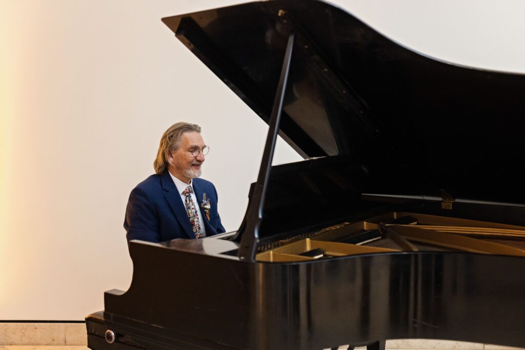 grooms dad plays piano during cocktail hour