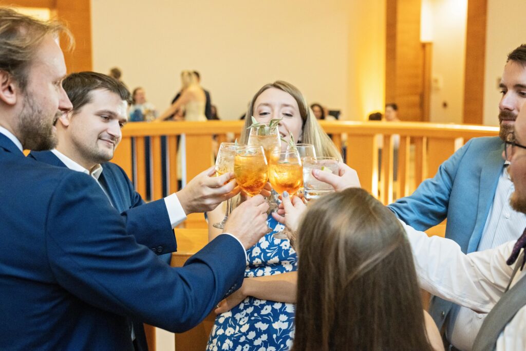 wedding guests cheers during cocktail hour