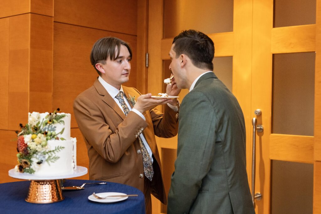 grooms private cake cutting feeding each other