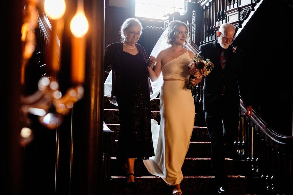 bride grand entrance for ceremony down grand staircase