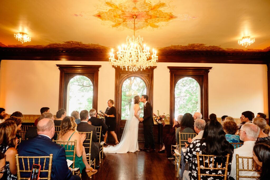 bride and groom ceremony kiss at historical mansion venue