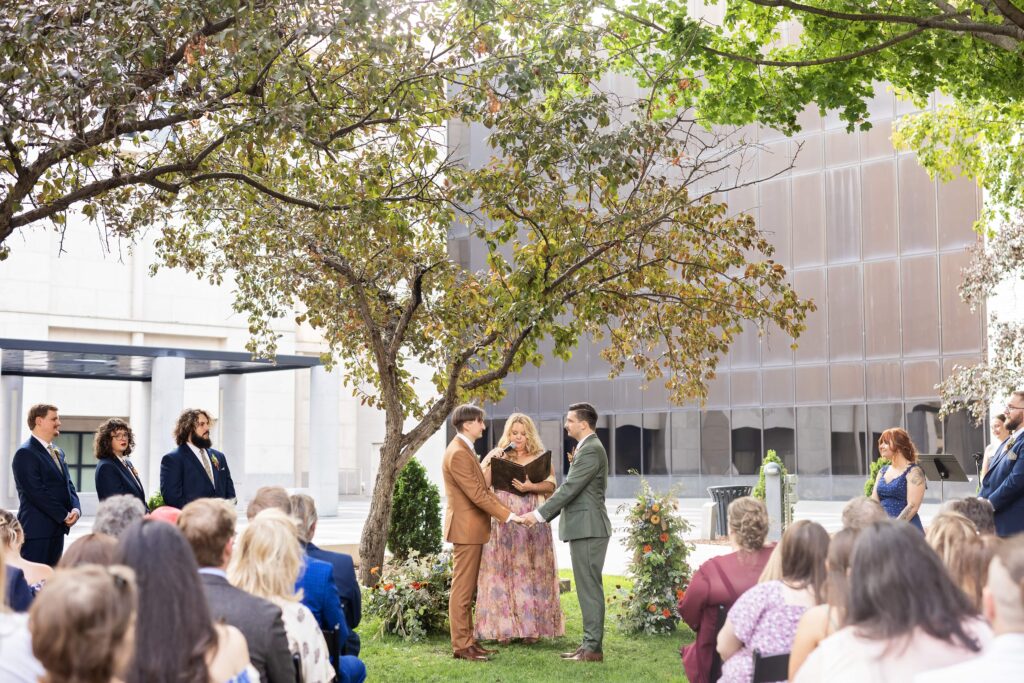 grooms wedding ceremony joining hands lgbtq wedding