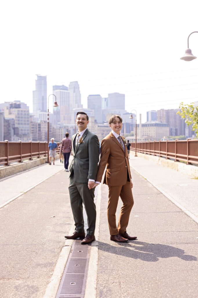 grooms wedding portraits on stone arch bridge