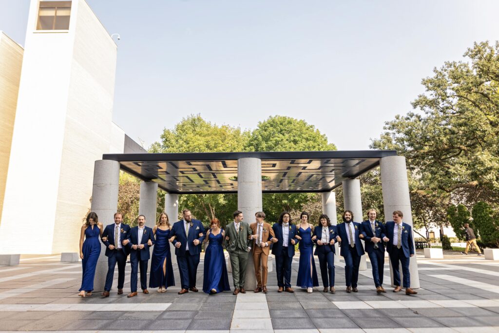 large wedding party in royal blue dresses and suits