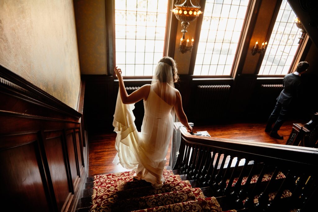 bride and groom first look on dramatic grand staircase