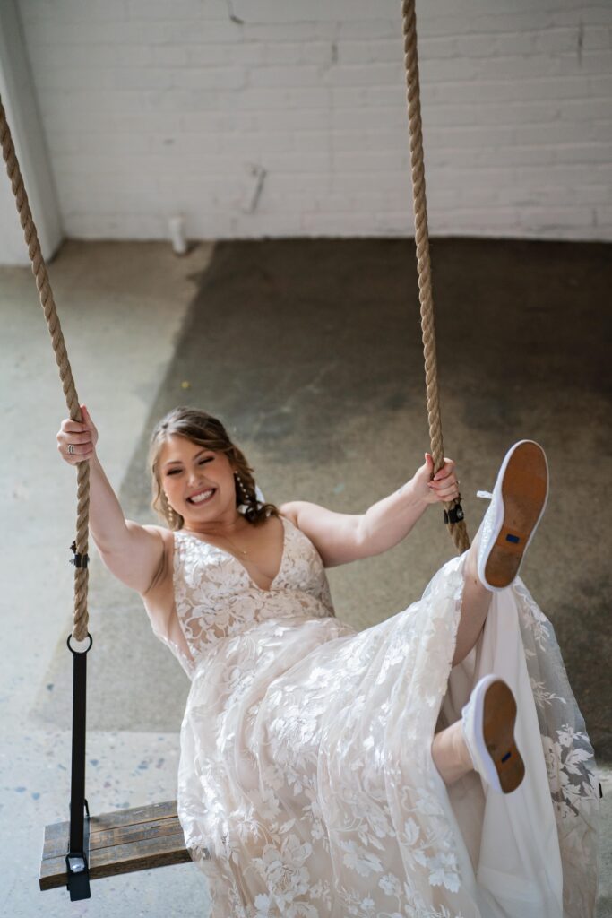 bride swinging fun portrait at Urban Daisy