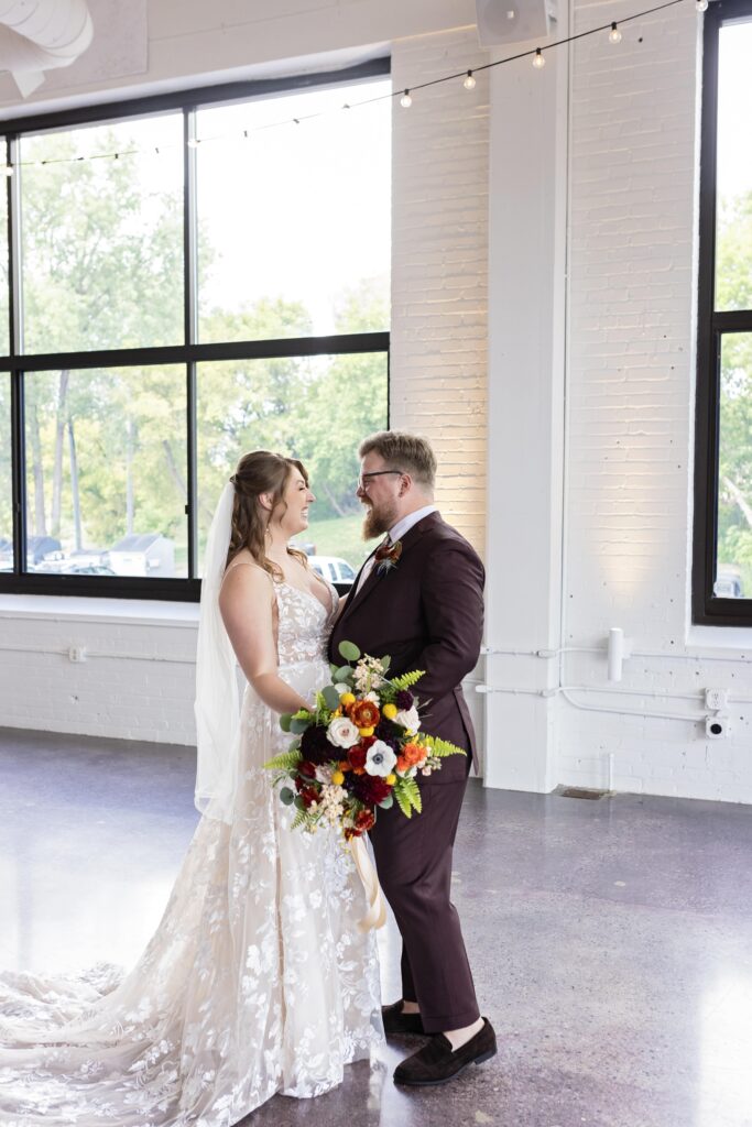 bride and groom first look hug