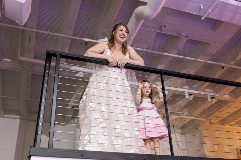 bride overlooking balcony for first dance