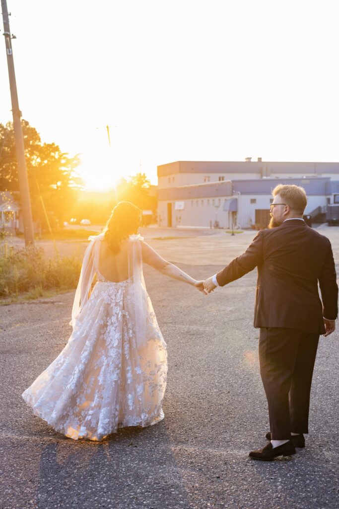 bride and groom holding hands sunset photos