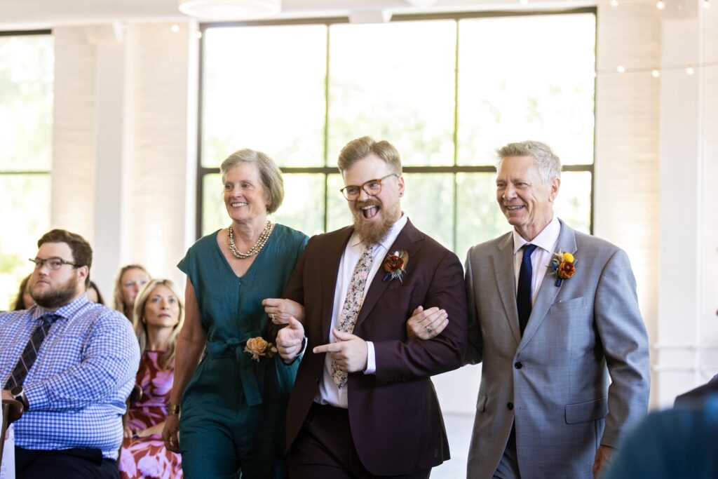 groom escorted by mother and father