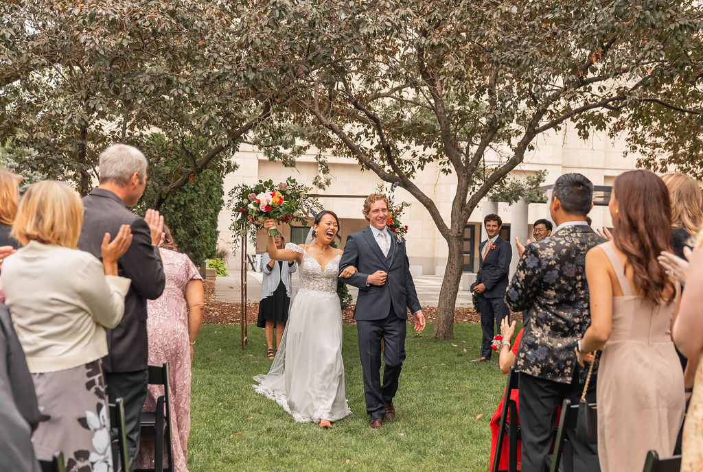 bride and groom celebratory recessional at outdoor ceremony