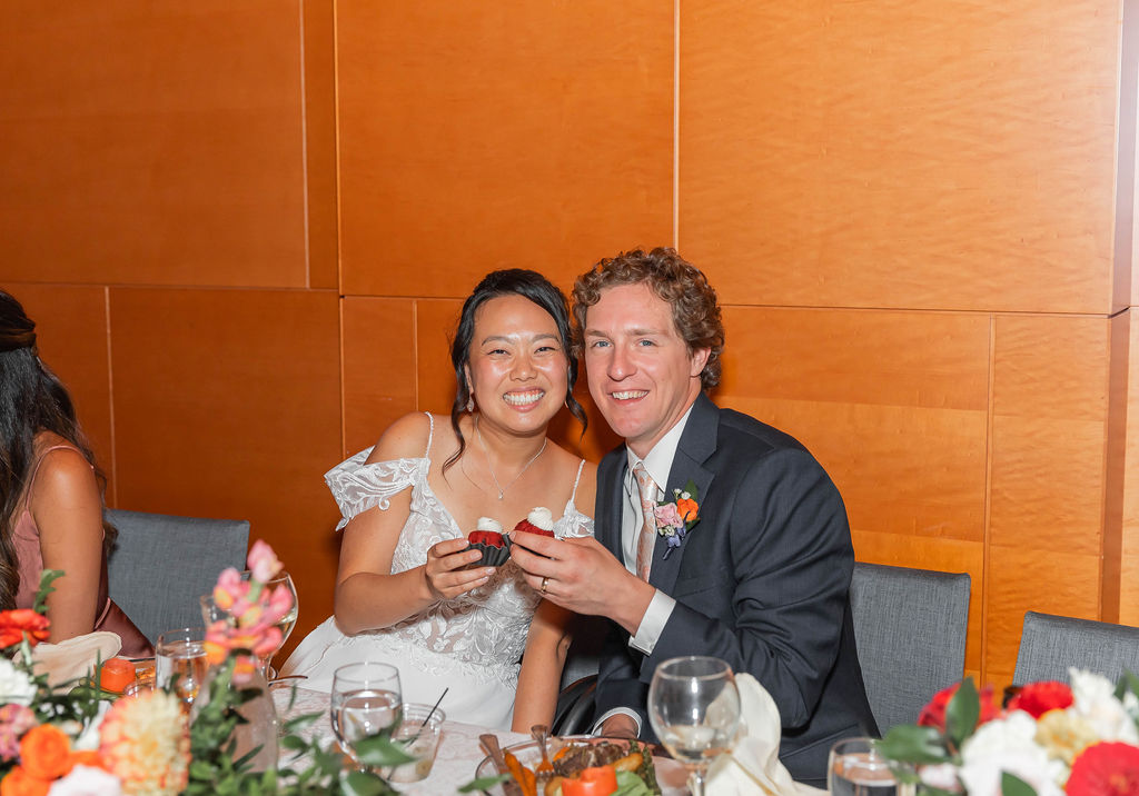 bride and groom posing with Nothing Bundt Cake dessert