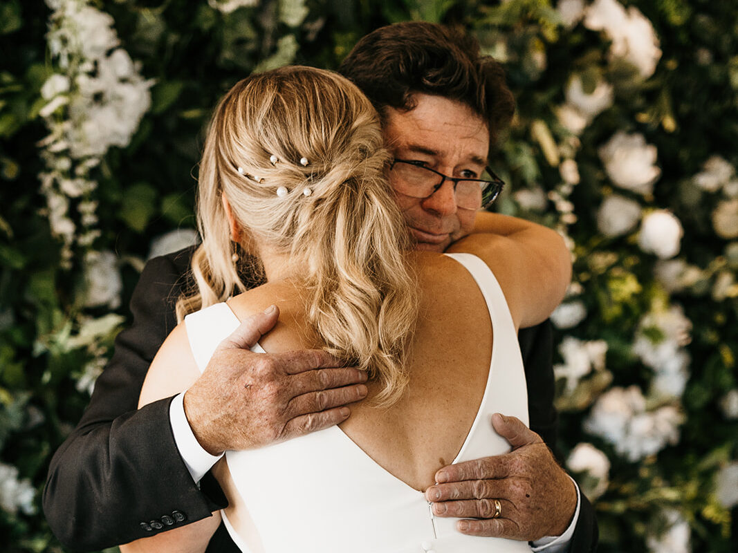 bride and dad hugging after emotional first look