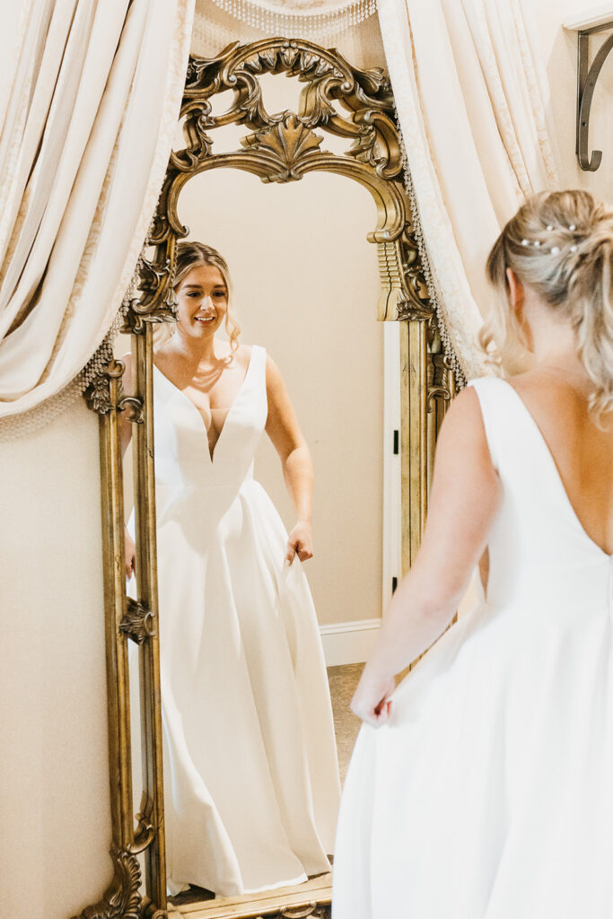 bride getting ready reflection in vintage gold mirror