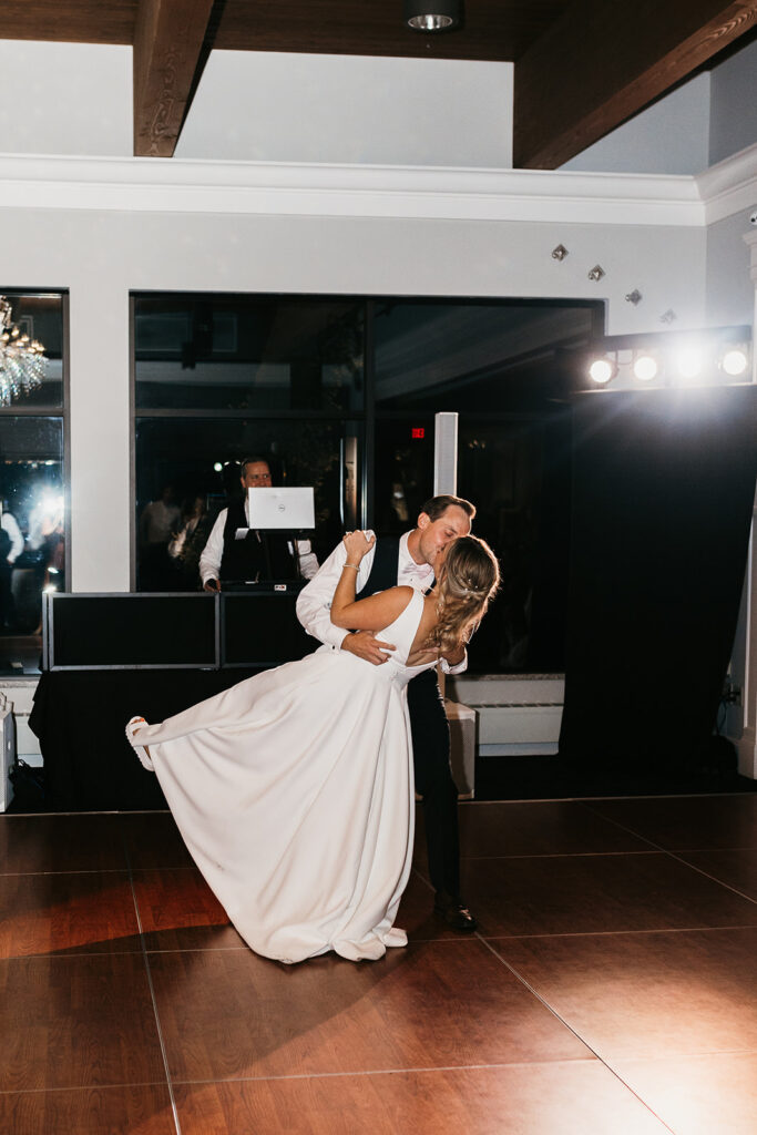 bride and groom first dance dip kiss