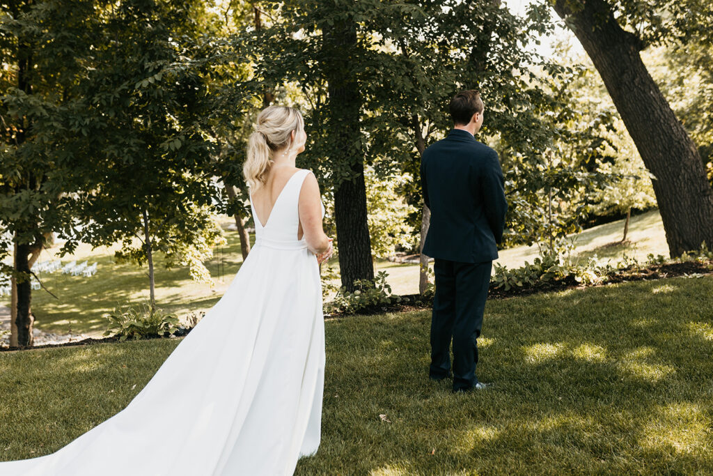 bride and groom first look at Leopold’s Mississippi Gardens 