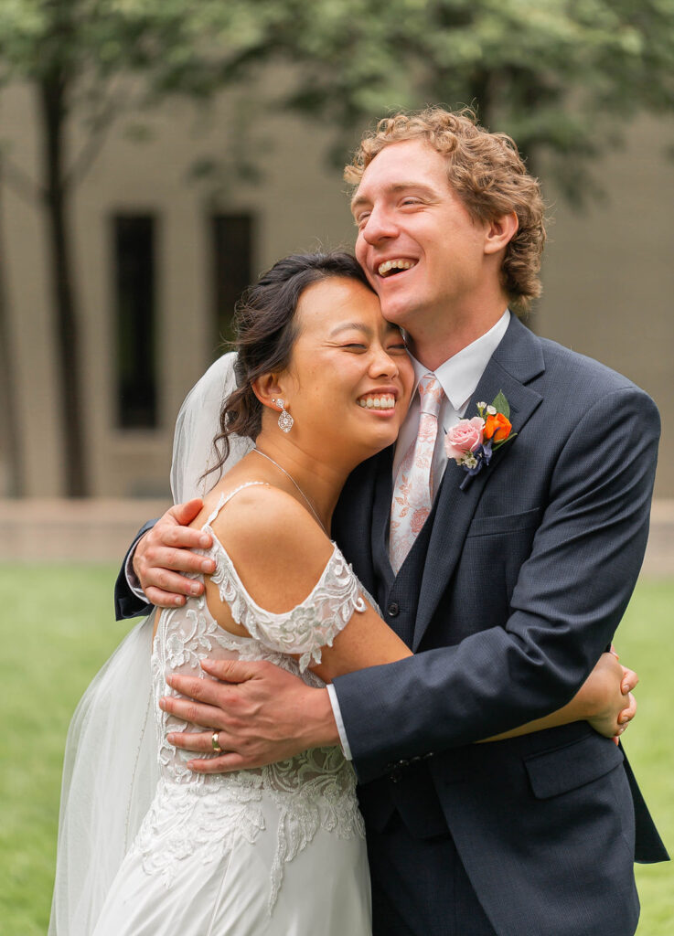 bride and groom laughing and hugging portrait