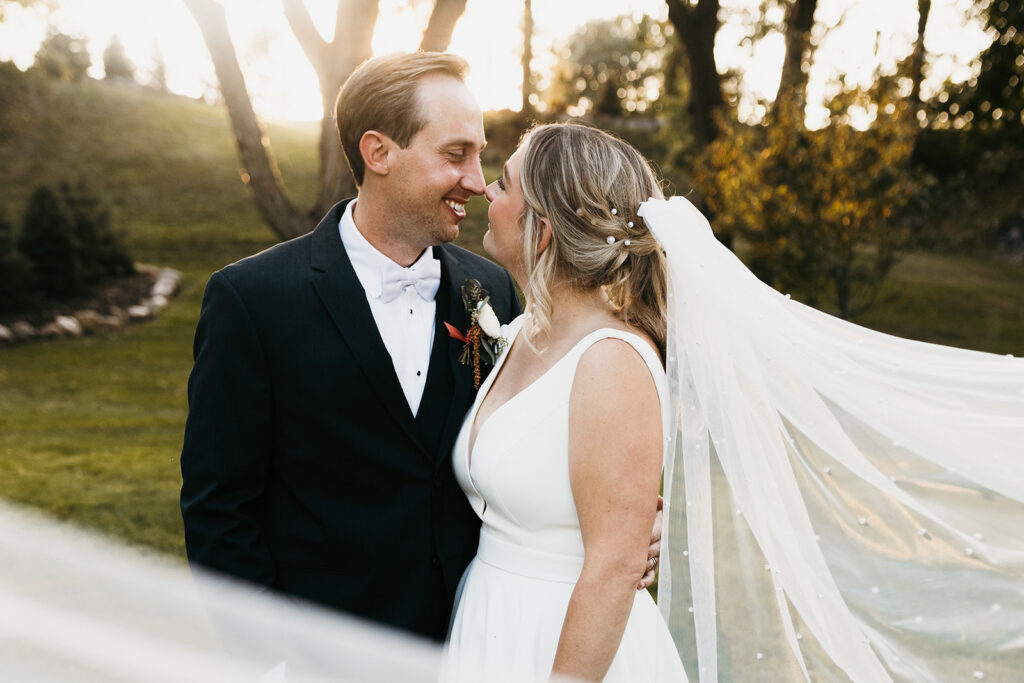 bride and groom sunset portrait with veil