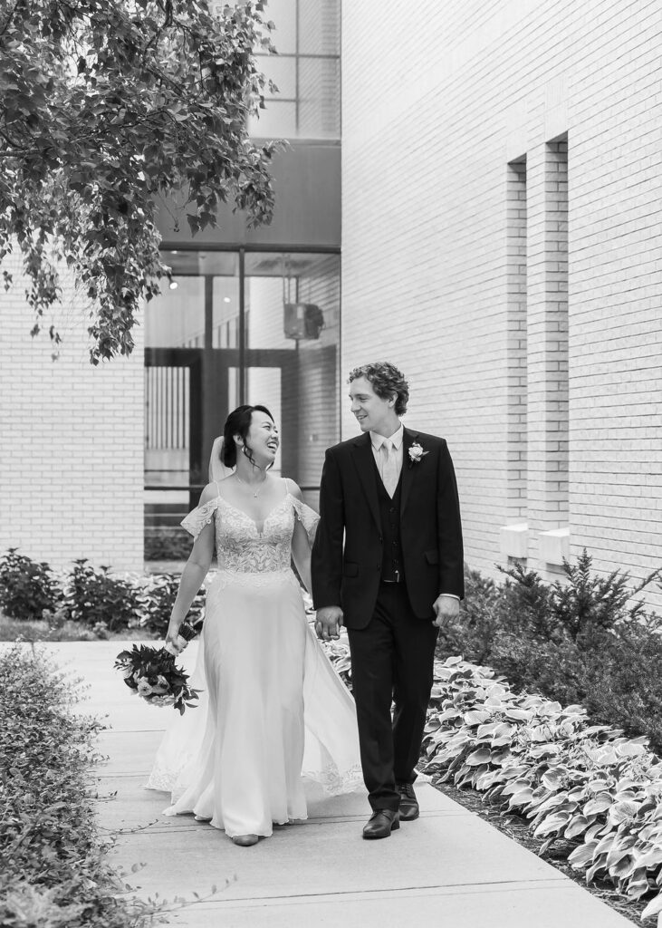 bride and groom walking black and white portrait