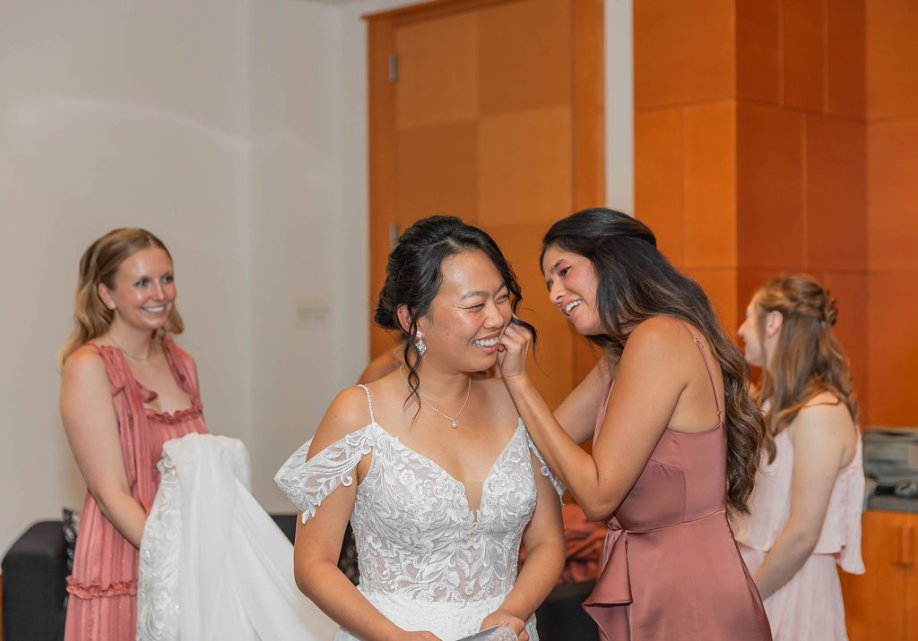 bridesmaids helping bride get ready for first look