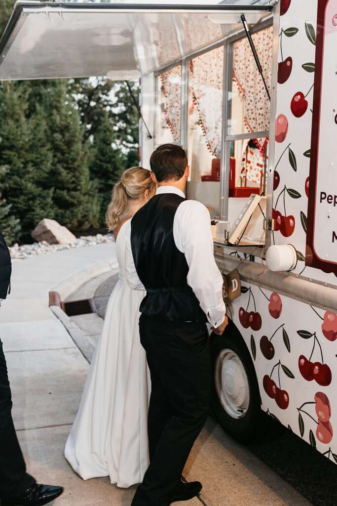 bride and groom ordering ice cream at The Cherry on Top Ice Cream Truck