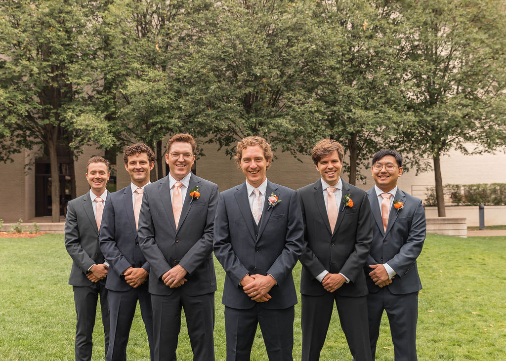 groomsmen photo in gray suits with colorful boutonnieres