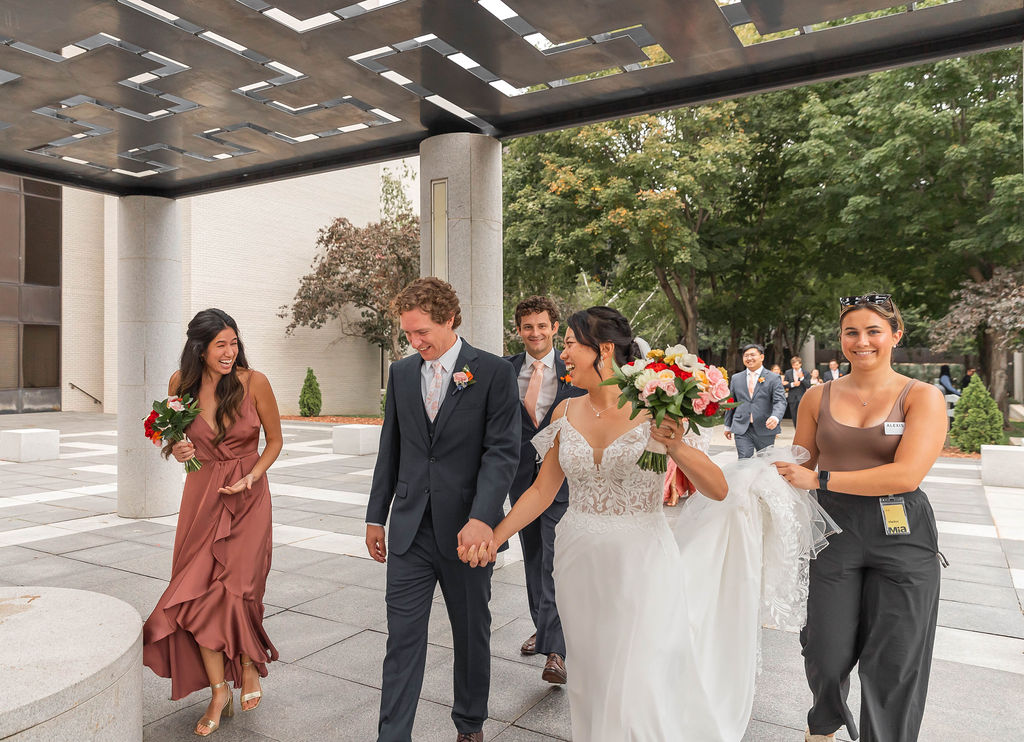 Keyed Up Events planner helping bride with her dress after ceremony