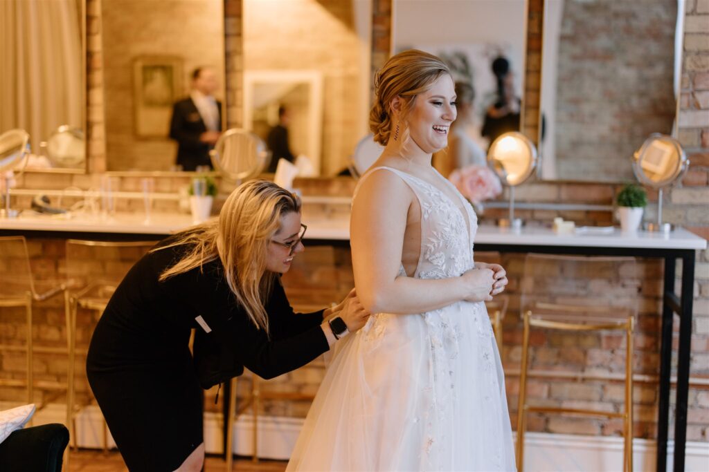 Keyed Up Events planner helping bride bustle her dress