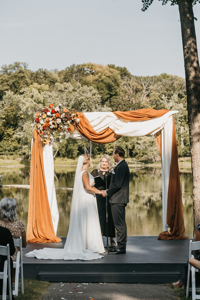 bride and groom holding hands during Leopold’s Mississippi Gardens ceremony