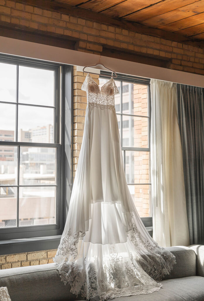 Wedding dress hanging by window details