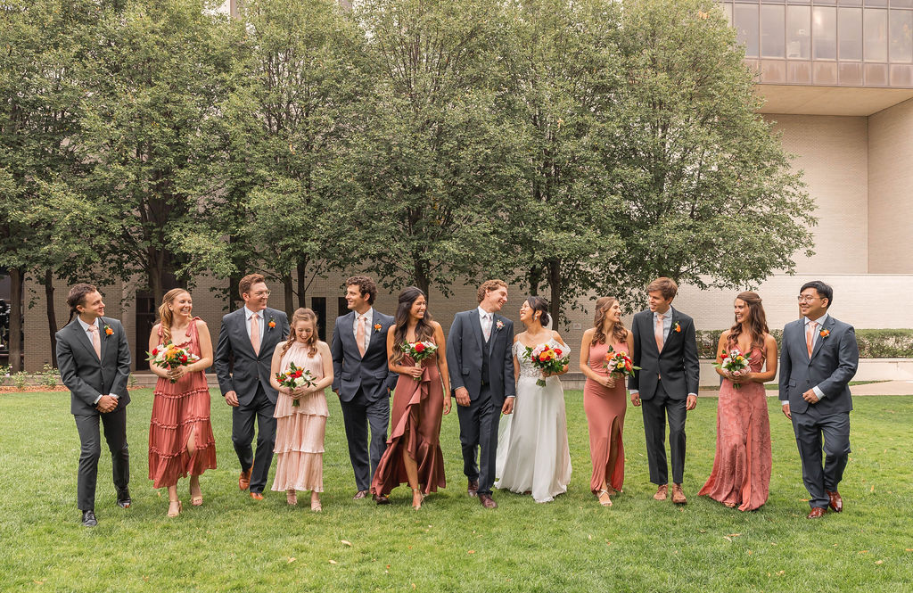 wedding party walking outside laughing