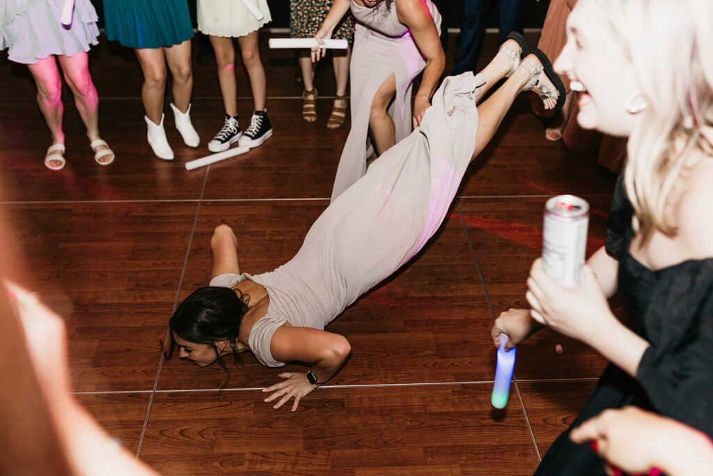 fun wedding dance floor bridesmaid doing the worm 