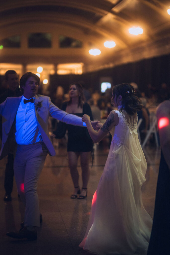 bride and groom dancing with guests at Union Depot wedding reception