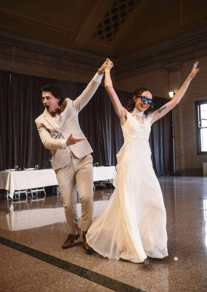 Bride and groom grand entrance wearing sunglasses at Union Depot