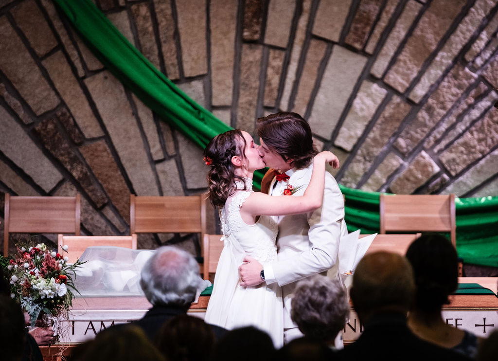 bride and groom ceremony kiss at Trinity Lutheran Church