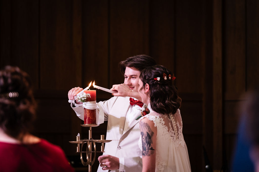 bride and groom unity candle at church ceremony