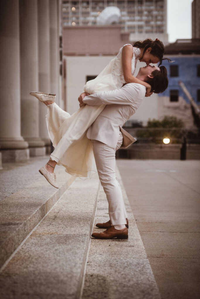 groom lifting bride fun wedding portrait