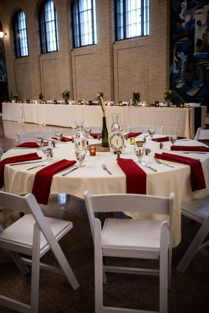 Guest tables with red napkins at Union Depot wedding reception