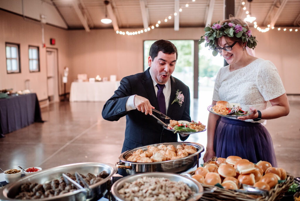 bride and groom excited for buffet food from Deco Catering at Gale Woods Farm