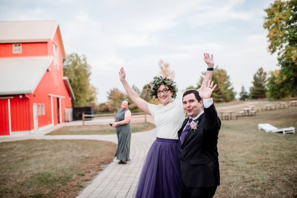 bride and groom celebrate after wedding ceremony at Gale Woods Farm