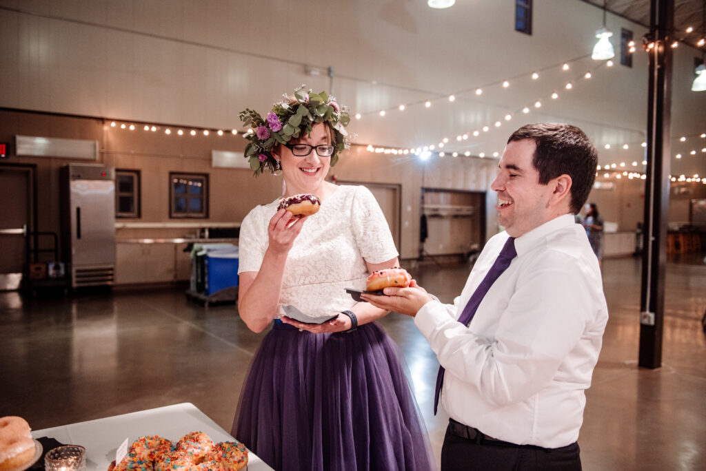 bride and groom with donuts for dessert photo