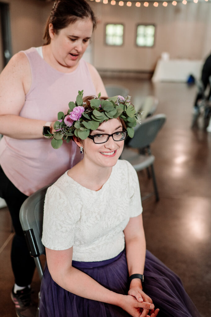 Dana from Keyed Up Events helping bride with flower crown