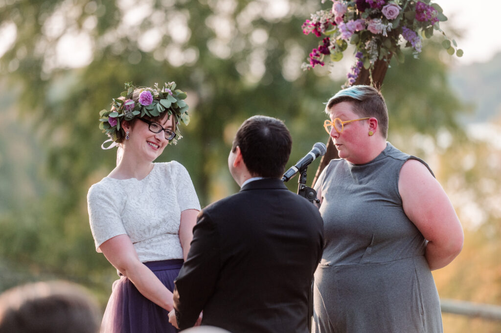 bride laughing during outdoor ceremony at Gale Woods Farm wedding 