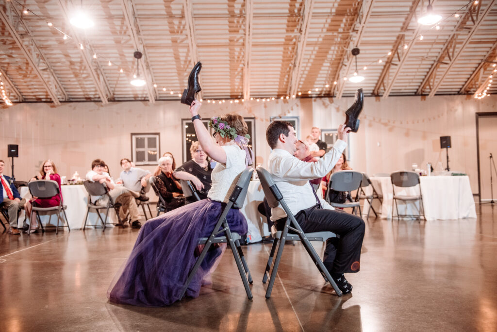 bride and groom playing shoe game at intimate Gale Woods Farm wedding