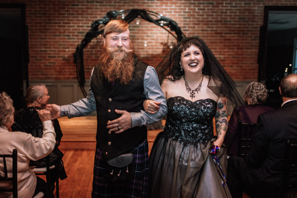 bride and groom celebrating during recessional 