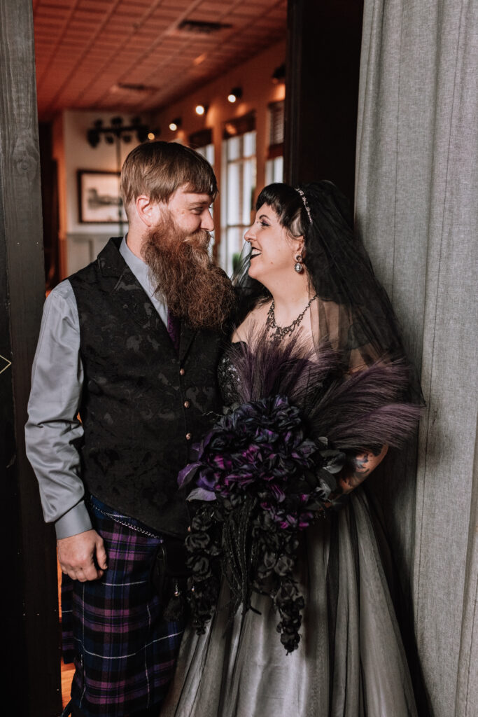 traditional bride and groom portrait smiling at each other