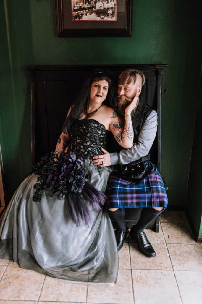 bride and groom portrait sitting on bench