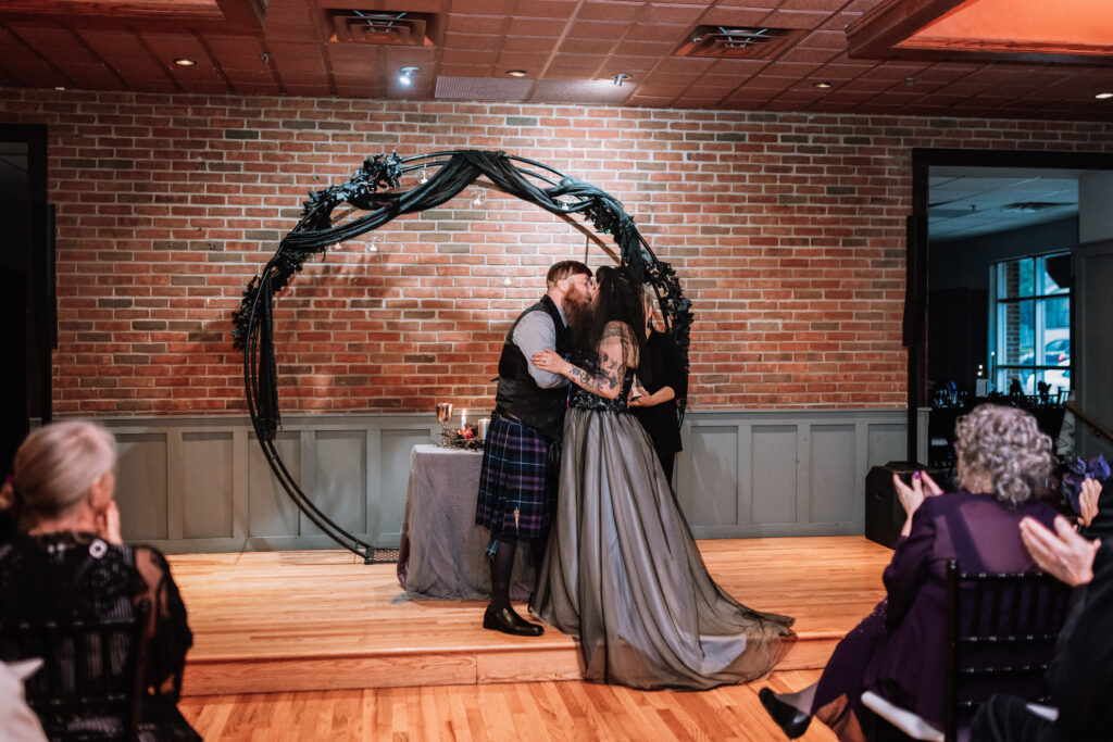 spooky wedding ceremony bride and groom kiss