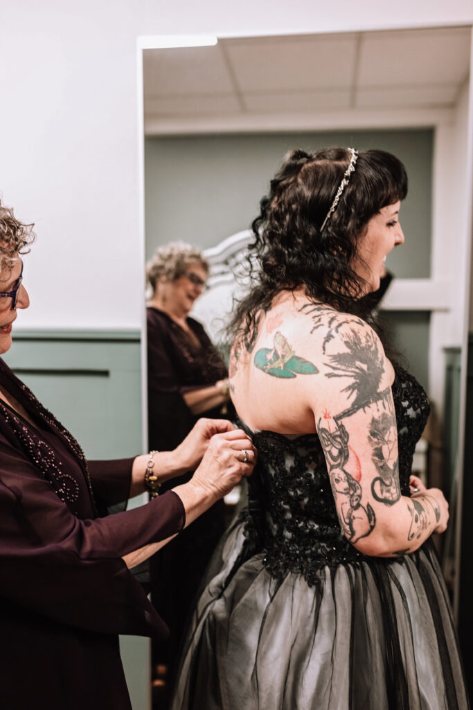 bride getting ready in black wedding gown