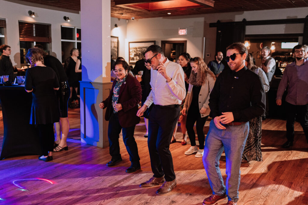 guests wearing sunglasses dancing at wedding reception